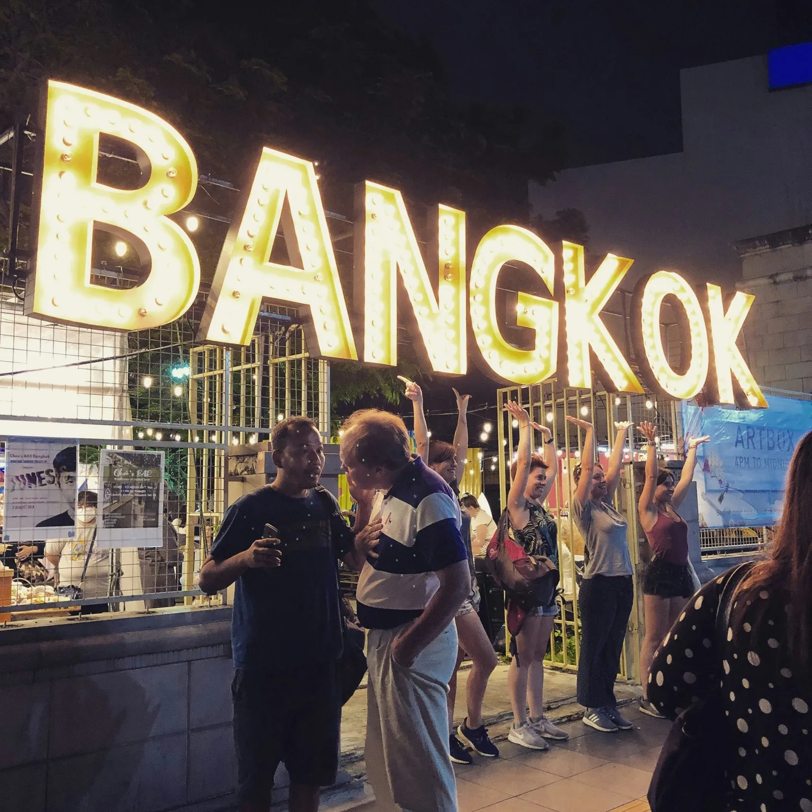 Bangkok ARTBOX illuminated marquee at night with crowds underneath - Sukhumvit nightlife scene